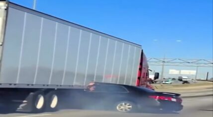Car gets hit by 18 wheeler and driver waves while truck drags them
