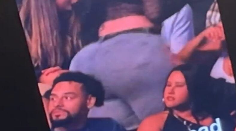 Woman with large back side twerks behind a man's head