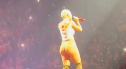 Doja Cat pokes her back side out during performance