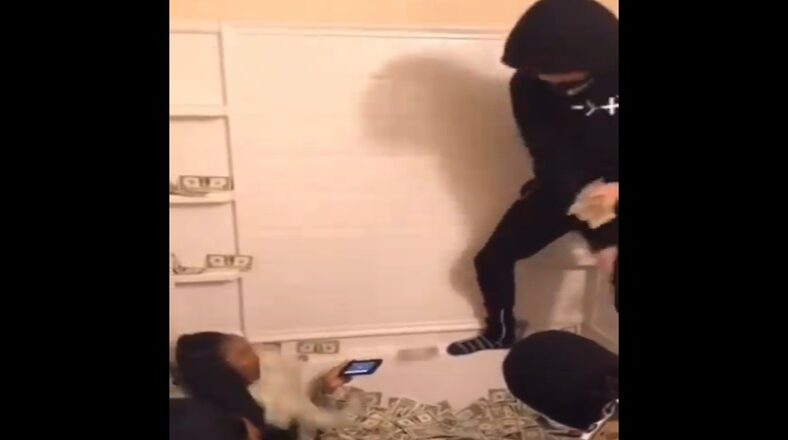 Rapper throws stack of cash directly in woman's face
