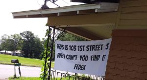 FedEx customer makes sign with address on it to get packages