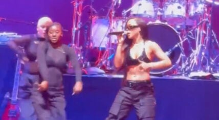 Serayah dressed as Aaliyah, performing "Are You That Somebody" at Essence Festival with backup dancers.
