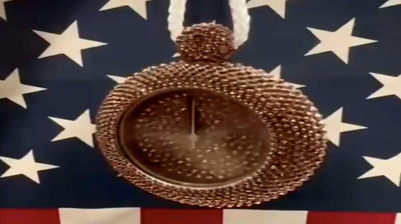 Flavor Flav gifts bronze clock chain to Jordan Chiles