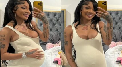 GloRilla posing in a mirror selfie wearing a beige jumpsuit, showing off a baby bump.