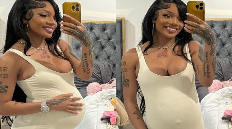 GloRilla posing in a mirror selfie wearing a beige jumpsuit, showing off a baby bump.