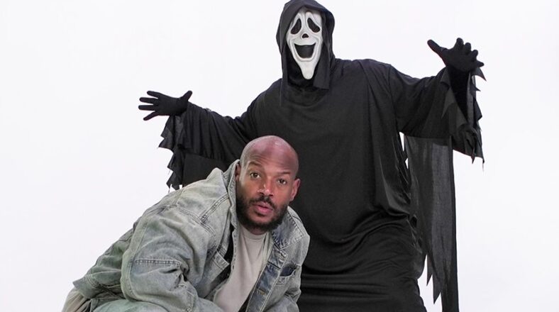 Marlon Wayans poses with a ghost character, announcing the Scary Movie reboot.