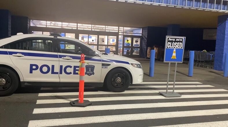 Police car parked outside a Walmart after a 19-year-old employee was found dead in the bakery oven