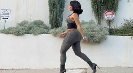 Saweetie walking in a figure-hugging outfit, showcasing her bold style and confidence in a viral Instagram video.
