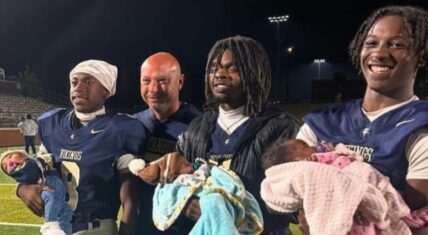 The woman’s three sons, all holding their newborns on a football field.