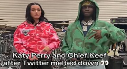 Katy Perry wearing a pink camouflage hoodie stands beside Chief Keef in a green camouflage hoodie inside a music studio. Text overlay reads: 'Katy Perry and Chief Keef after Twitter meltdown 👀'