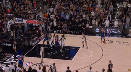 High-angle view of Game 5 of the 2026 NBA Finals at Frost Bank Center, with New York Knicks (blue) and San Antonio Spurs (white) players clustered under the basket during a key fourth-quarter play as a packed crowd looks on. Scoreboard shows 88-88 with 1:14 remaining.