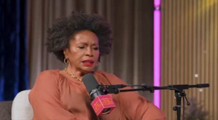 Jenifer Lewis speaking expressively into a pink-branded microphone during her interview on Keke Palmer's 
