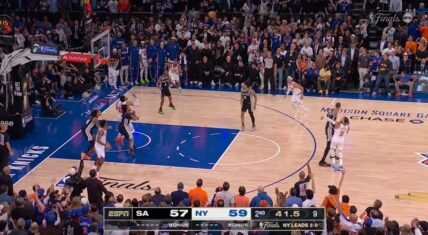 Action shot from Game 3 of the 2026 NBA Finals at Madison Square Garden. The San Antonio Spurs trail the New York Knicks 57-59 in the second quarter with 4:15 remaining as players battle near the basket in front of a packed, energetic crowd.