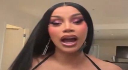 Cardi B speaking directly to the camera during her Instagram Live after the 2026 BET Awards, with long straight black hair, pink eyeshadow, and large dangling earrings.