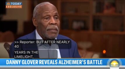 Close-up of Danny Glover in a blue suit during his TODAY show exclusive interview with Lester Holt, revealing his battle with Alzheimer's disease, featuring reporter text overlay and 