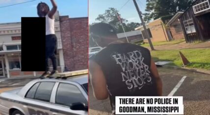 Split-screen still from viral video in Goodman, Mississippi: Left shows a dreadlocked man standing on a police car's roof with one arm raised (face blacked out); right shows a man in a "HARD WORK NEVER STOPS" sleeveless shirt near a building. Overlay text reads "THERE ARE NO POLICE IN GOODMAN, MISSISSIPPI."