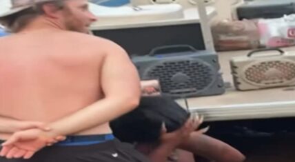 Man at Lake Norman enjoying his dance with a woman while his girlfriend, who is not in the shot, watches in visible frustration.